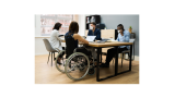 people around a table, one with a wheelchair