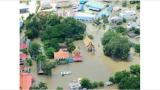 photo of block that has been flooded. Tops of tree and roofs are showing