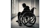 black and white photo of person in a wheelchair looking depressed