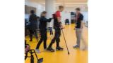 a blurred photo of a patient being helped to talk by a rehabilitation therapist