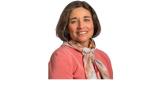color photo of Linda Ehrlich-Jones, a middle aged white woman with shirt brown hair and a pink jacket