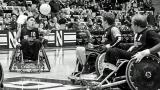 Wheelchair Rugby match. Athlete goes after ball in the air.