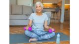 photo of an older woman on a yoga mat with weights